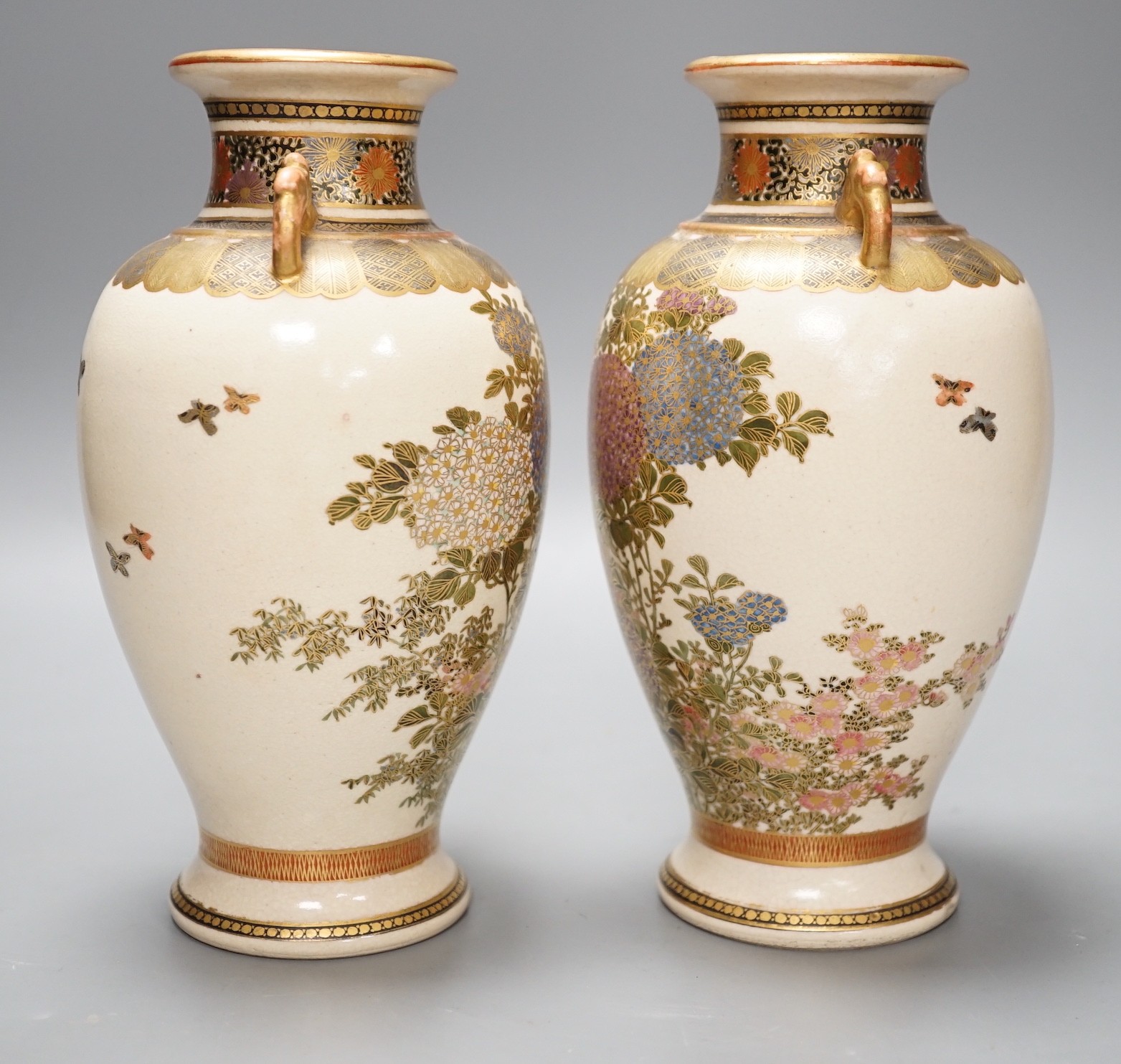 A pair of Japanese Satsuma pottery vases, 18.5cms high